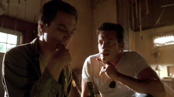 Movie still from “Bug” (2006), directed by William Friedkin – Two young men are sitting in a room; Close Up shot, Low angle