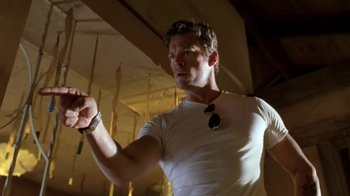 Movie still from “Bug” (2006), directed by William Friedkin – A man in a white shirt is holding something up; Medium shot, Low angle