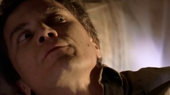 Movie still from “Bug” (2006), directed by William Friedkin – A man's face with a blurry background; Extreme Close Up shot, Low angle
