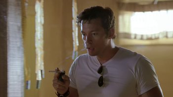 Movie still from “Bug” (2006), directed by William Friedkin – A man smoking a cigarette while wearing sunglasses; Close Up shot, Over the shoulder angle