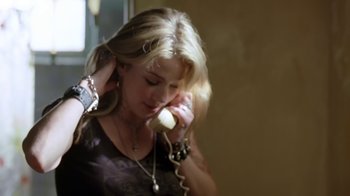 Movie still from “Bug” (2006), directed by William Friedkin – A woman talking on a phone while wearing a necklace; Close Up shot, Over the shoulder angle