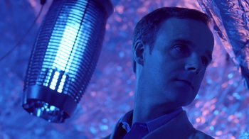 Movie still from “Bug” (2006), directed by William Friedkin – A person wearing a suit and tie; Close Up shot, Low angle