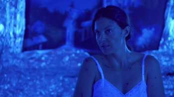 Movie still from “Bug” (2006), directed by William Friedkin – A woman in a white dress is in a dark room; Medium shot, High angle
