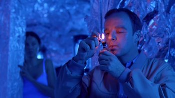 Movie still from “Bug” (2006), directed by William Friedkin – A man lighting a cigarette in a dark room; Close Up shot, Low angle
