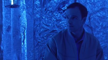 Movie still from “Bug” (2006), directed by William Friedkin – A man standing in front of a wall covered in aluminum foil; Medium shot, High angle