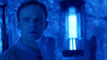 Movie still from “Bug” (2006), directed by William Friedkin – A man standing in front of an electric lamp; Close Up shot, Over the shoulder angle