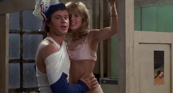Movie still from “Bull Durham” (1988), directed by Ron Shelton – A man and a woman are posing for a picture; Medium shot, Low angle