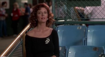 Movie still from “Bull Durham” (1988), directed by Ron Shelton – A woman with red hair wearing a black top; Medium shot, Over the shoulder angle