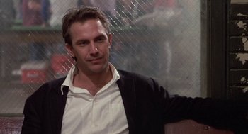 Movie still from “Bull Durham” (1988), directed by Ron Shelton – A person wearing a white shirt; Close Up shot, Over the shoulder angle