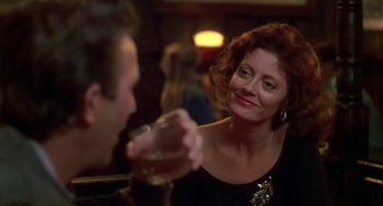 Movie still from “Bull Durham” (1988), directed by Ron Shelton – A woman sitting next to a man holding a drink; Close Up shot, Over the shoulder angle