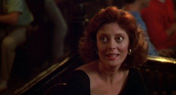 Movie still from “Bull Durham” (1988), directed by Ron Shelton – A woman with red hair and a black top; Close Up shot, Over the shoulder angle