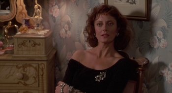 Movie still from “Bull Durham” (1988), directed by Ron Shelton – A woman in a black dress and silver jewelry; Close Up shot, Over the shoulder angle