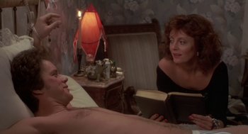 Movie still from “Bull Durham” (1988), directed by Ron Shelton – A man and a woman reading a book in a room; Medium shot, Over the shoulder angle