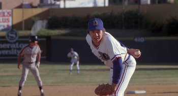 Movie still from “Bull Durham” (1988), directed by Ron Shelton – A baseball player in a blue and white baseball uniform; Medium shot, Over the shoulder angle