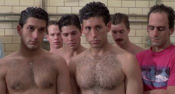 Movie still from “Bull Durham” (1988), directed by Ron Shelton – A group of men standing next to each other in a bathroom; Close Up shot, High angle