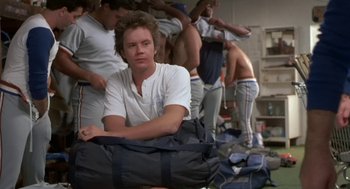 Movie still from “Bull Durham” (1988), directed by Ron Shelton – A group of men standing next to each other in a room; Medium shot, Over the shoulder angle