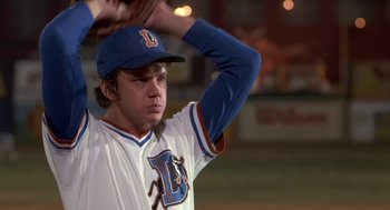 Movie still from “Bull Durham” (1988), directed by Ron Shelton – A young baseball player is holding his mitt up; Close Up shot, Low angle