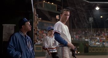 Movie still from “Bull Durham” (1988), directed by Ron Shelton – A baseball player holding a baseball bat in front of a crowd; Medium shot, Low angle