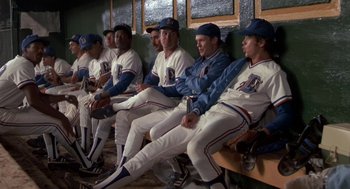 Movie still from “Bull Durham” (1988), directed by Ron Shelton – A group of baseball players sitting in a dugout; Wide shot, High angle