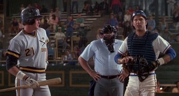 Movie still from “Bull Durham” (1988), directed by Ron Shelton – A group of men standing next to each other on a baseball field; Medium shot, Over the shoulder angle