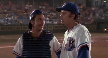 Movie still from “Bull Durham” (1988), directed by Ron Shelton – Two baseball players talking to each other at a baseball game; Medium shot, Over the shoulder angle