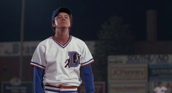 Movie still from “Bull Durham” (1988), directed by Ron Shelton – A man in a baseball uniform looking up; Medium shot, Low angle