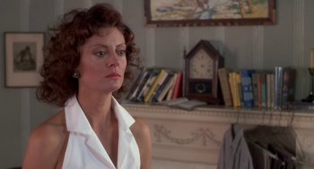 Movie still from “Bull Durham” (1988), directed by Ron Shelton – A person sitting in front of a fireplace; Close Up shot, Over the shoulder angle