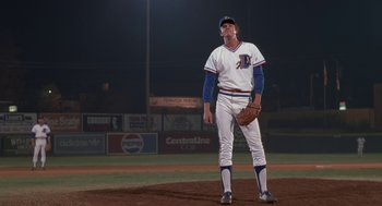 Movie still from “Bull Durham” (1988), directed by Ron Shelton – A baseball player is standing on a field; Medium shot, Low angle