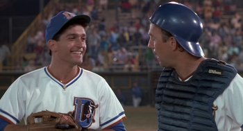 Movie still from “Bull Durham” (1988), directed by Ron Shelton – Two baseball players talking to each other at a baseball game; Medium shot, Over the shoulder angle