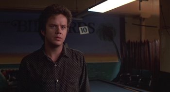 Movie still from “Bull Durham” (1988), directed by Ron Shelton – A man standing in front of a pool table in a room; Close Up shot, Low angle