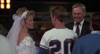 Movie still from “Bull Durham” (1988), directed by Ron Shelton – A man and a woman are talking to a man in a baseball uniform; Medium shot, Over the shoulder angle