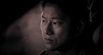 Movie still from “Bullet to the Head” (2012), directed by Walter Hill – A black - and - white photo of a man's face; Extreme Close Up shot, Low angle