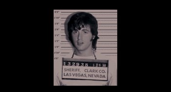 Movie still from “Bullet to the Head” (2012), directed by Walter Hill – A black and white photo of a man in a police mugshot; Close Up shot, Overhead angle