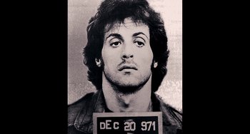 Movie still from “Bullet to the Head” (2012), directed by Walter Hill – A black - and - white photo of sylvester stallone's mugshot; Close Up shot, Overhead angle