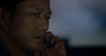 Movie still from “Bullet to the Head” (2012), directed by Walter Hill – A person holding a cell phone to his ear; Close Up shot, Low angle