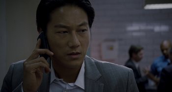 Movie still from “Bullet to the Head” (2012), directed by Walter Hill – A person talking on a cell phone; Close Up shot, Low angle