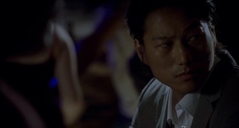 Movie still from “Bullet to the Head” (2012), directed by Walter Hill – A person sitting in a room; Close Up shot, Over the shoulder angle