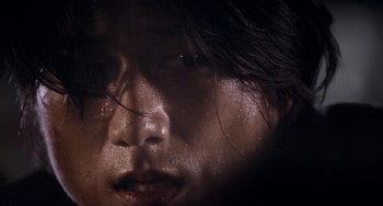 Movie still from “Bullet to the Head” (2012), directed by Walter Hill – A person's face with water droplets on it; Extreme Close Up shot, Low angle
