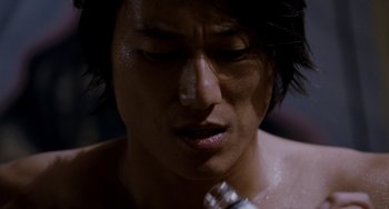 Movie still from “Bullet to the Head” (2012), directed by Walter Hill – A person with wet hair; Close Up shot, Low angle