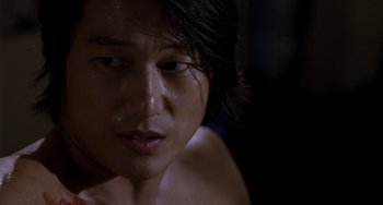 Movie still from “Bullet to the Head” (2012), directed by Walter Hill – A man's face in the dark; Close Up shot, Over the shoulder angle