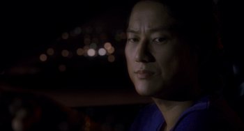 Movie still from “Bullet to the Head” (2012), directed by Walter Hill – A man's face in the dark; Close Up shot, Over the shoulder angle