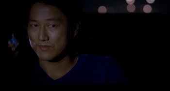 Movie still from “Bullet to the Head” (2012), directed by Walter Hill – A man sitting in a dark room at night; Close Up shot, Over the shoulder angle