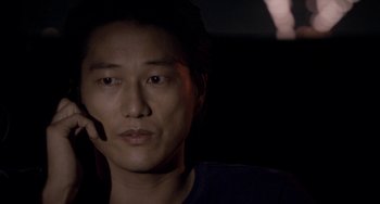 Movie still from “Bullet to the Head” (2012), directed by Walter Hill – A person wearing a headset; Close Up shot, Over the shoulder angle