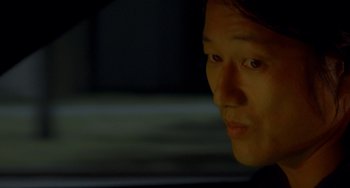 Movie still from “Bullet to the Head” (2012), directed by Walter Hill – A man sitting in a car at night looking off to his right; Close Up shot, Over the shoulder angle