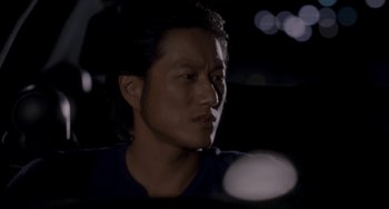 Movie still from “Bullet to the Head” (2012), directed by Walter Hill – A person with long black hair; Close Up shot, Over the shoulder angle