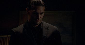 Movie still from “Bullet to the Head” (2012), directed by Walter Hill – A person wearing a suit and tie; Close Up shot, Low angle