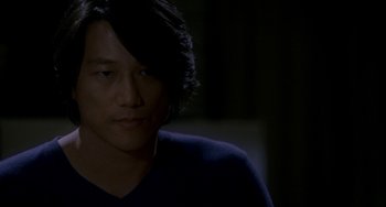 Movie still from “Bullet to the Head” (2012), directed by Walter Hill – A person with long black hair; Close Up shot, Over the shoulder angle