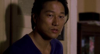 Movie still from “Bullet to the Head” (2012), directed by Walter Hill – A person with long black hair; Close Up shot, Over the shoulder angle