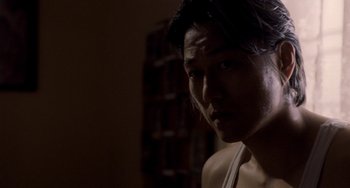 Movie still from “Bullet to the Head” (2012), directed by Walter Hill – A person in a dark room; Close Up shot, Low angle