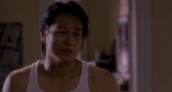Movie still from “Bullet to the Head” (2012), directed by Walter Hill – A man with long black hair wearing a white tank top; Close Up shot, Over the shoulder angle